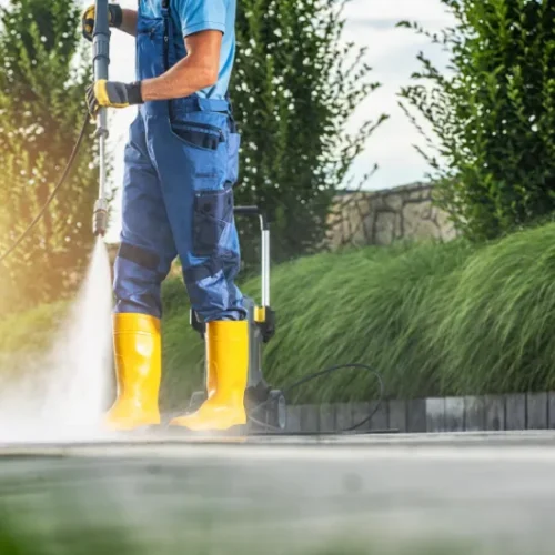 Experienced technicians using advanced equipment for pressure washing a residential driveway in Cairns