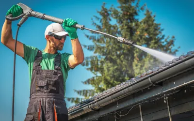 Worker Soft washing a roof in Cairns